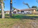 Ranch style home with a spacious lawn and mature trees at 7801 Rolling Grove W Dr, Lakeland, FL 33810