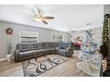 Living room featuring a sectional sofa, hardwood floors, and a Christmas tree at 8309 Porch Ct, Lakeland, FL 33810