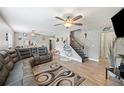 Spacious living room with grey sectional sofa and hardwood floors at 8309 Porch Ct, Lakeland, FL 33810