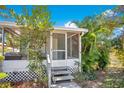 Charming house with a screened porch and lush landscaping at 1133 N Brunnell Pkwy, Lakeland, FL 33805