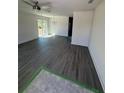 Spacious living room featuring modern ceiling fan and new flooring at 1265 Dosseywood Ln, Lakeland, FL 33811