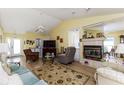 Comfortable living room featuring hardwood flooring, a fireplace, and plenty of space for entertaining at 1452 Grand Cayman Cir, Winter Haven, FL 33884