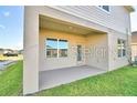 Covered back patio with access to the backyard at 1509 Leamington Ln, Winter Haven, FL 33884