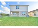 Large grassy backyard with home's back elevation visible at 1509 Leamington Ln, Winter Haven, FL 33884