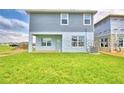 Home's backyard features a grassy area and a spacious patio at 1513 Leamington Ln, Winter Haven, FL 33884