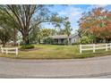 House exterior showcasing curb appeal and large trees at 1628 Lakewood S Dr, Lakeland, FL 33813