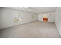 Spacious living room with neutral carpeting and ceiling fan at 1628 Lakewood S Dr, Lakeland, FL 33813
