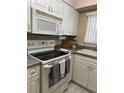 Kitchen with stove, microwave, and lots of cabinets at 1700 6Th Nw St # C27, Winter Haven, FL 33881