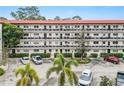 Two-story building with parking and tropical landscaping at 200 El Camino Dr # 309, Winter Haven, FL 33884