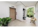 Building hallway with elevator, stairs, and seating at 200 El Camino Dr # 309, Winter Haven, FL 33884