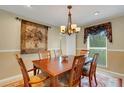 Dining room with wooden table and floral tapestry at 2620 Jonila Ave, Lakeland, FL 33803