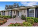 House entrance with brick walkway and lush landscaping at 2620 Jonila Ave, Lakeland, FL 33803