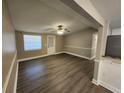 Open living room with wood floors, ceiling fan, and a neutral color palette at 3016 Hutchins St, Eaton Park, FL 33840