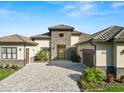 Luxury home with stone accents, tile roof, and a paver driveway at 3131 Sanctuary Cir, Lakeland, FL 33803