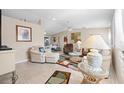 Spacious living room with light colored furniture and tile floors at 3173 Sand Trap Ct, Lakeland, FL 33810