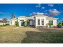 White two-story house with palm trees and walkway at 5272 Riverlake Dr, Bartow, FL 33830