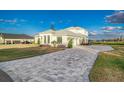 Home features a large driveway and partial water view at 5272 Riverlake Dr, Bartow, FL 33830