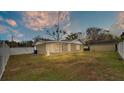 Back of the house showing a screened porch, a large yard, and a detached garage at 616 W Remington Rd, Lakeland, FL 33813