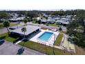 Community pool and shuffleboard courts are featured in this aerial view at 646 Cottage Ln, Lakeland, FL 33803