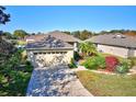Well-manicured home featuring an attached garage and attractive landscaping at 6555 Lake Clark Dr, Lakeland, FL 33813