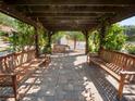 Relaxing pergola with wooden benches, perfect for outdoor seating at 6611 Sweetbriar Ln, Lakeland, FL 33813