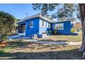 Side view of a blue house with a screened porch at 727 Bonnie Dr, Lakeland, FL 33803