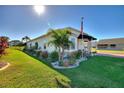 One-story home with side yard landscaping and palm trees at 1039 Motorcoach Dr, Polk City, FL 33868