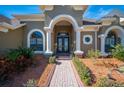 Grand entrance with double doors, arched entryway, and a brick walkway at 1217 Vista Hills Dr, Lakeland, FL 33813