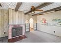 Living room with fireplace and wood paneling at 127 Colonial Dr, Auburndale, FL 33823