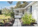 Side view showing screened porch and walkway with landscaping at 1317 W Belmar St, Lakeland, FL 33815