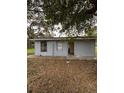 Small gray shed in the backyard with a yard at 1408 28Th Nw St, Winter Haven, FL 33881