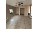 Spacious living room with tile flooring and ceiling fan at 1408 28Th Nw St, Winter Haven, FL 33881