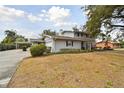 Two-story house with gray brick exterior, attached garage, and landscaped yard at 1521 Leighton Ave, Lakeland, FL 33803