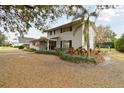 Two-story house with gray brick exterior, landscaped yard, and walkway at 1521 Leighton Ave, Lakeland, FL 33803