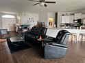 Living room with reclining theater seating and dark floors at 1543 Hollow Tree Ct, Lakeland, FL 33811