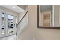 Bright entryway with tile flooring, staircase, and view to the exterior at 1559 Carey Palm Cir, Kissimmee, FL 34747