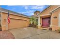 A charming front entrance with a burgundy door and well manicured landscaping at 178 Magneta Loop, Auburndale, FL 33823