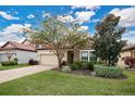 Landscaped front yard with a two-car garage and stone accents at 1832 Prima Vista Dr, Lakeland, FL 33810