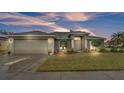 Attractive house exterior with landscaping at dusk at 2105 Normandy Heights Ln, Winter Haven, FL 33880