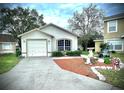 House exterior showcasing a well-maintained lawn and a paved driveway at 2141 Sandy Hook, Lakeland, FL 33813