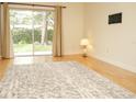 Bright living room featuring hardwood floors, neutral walls, an area rug, and sliding glass doors to the outdoors at 223 Windsor St # 3A, Lakeland, FL 33803