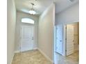 Clean entryway with tile floor, neutral walls, and access to bathroom at 237 Piave St, Haines City, FL 33844