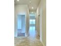 Bright hallway with tile flooring and access to other rooms at 237 Piave St, Haines City, FL 33844