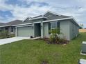 Lovely one-story home with lush lawn, a two-car garage, and tidy landscaping around the entrance at 245 Piave St, Haines City, FL 33844