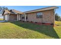 Brick house with a neatly landscaped yard at 3220 Cherry Hill S Cir, Lakeland, FL 33810