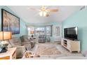 Bright living room with light walls, comfy seating, and a large TV at 3273 Pebble Bend Dr, Lakeland, FL 33810