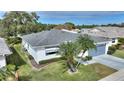 Single-story home with a gray roof, attached garage, and landscaped yard at 3618 Highland Fairways Blvd, Lakeland, FL 33810