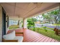 Relaxing front porch with wooden deck, ceiling fan, and view of the street at 401 E Belmar St, Lakeland, FL 33803