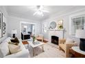 Bright living room features white sofa, fireplace, and hardwood floors at 401 E Belmar St, Lakeland, FL 33803