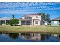 Two-story house with screened patio overlooking a canal at 4048 Windchime Ln, Lakeland, FL 33811